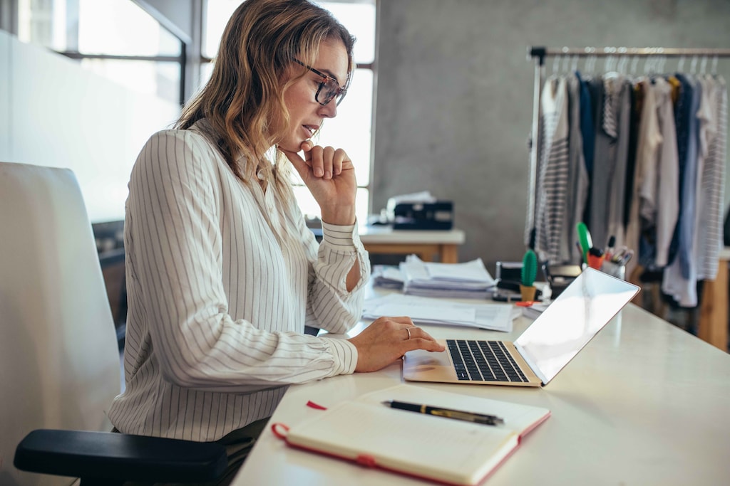 Businesswoman sitting at her desk and working on laptop