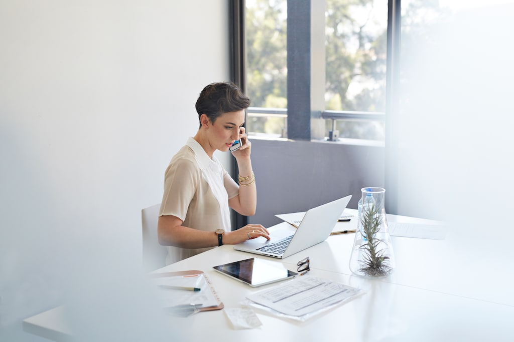 Businesswoman on the phone & in front of laptop