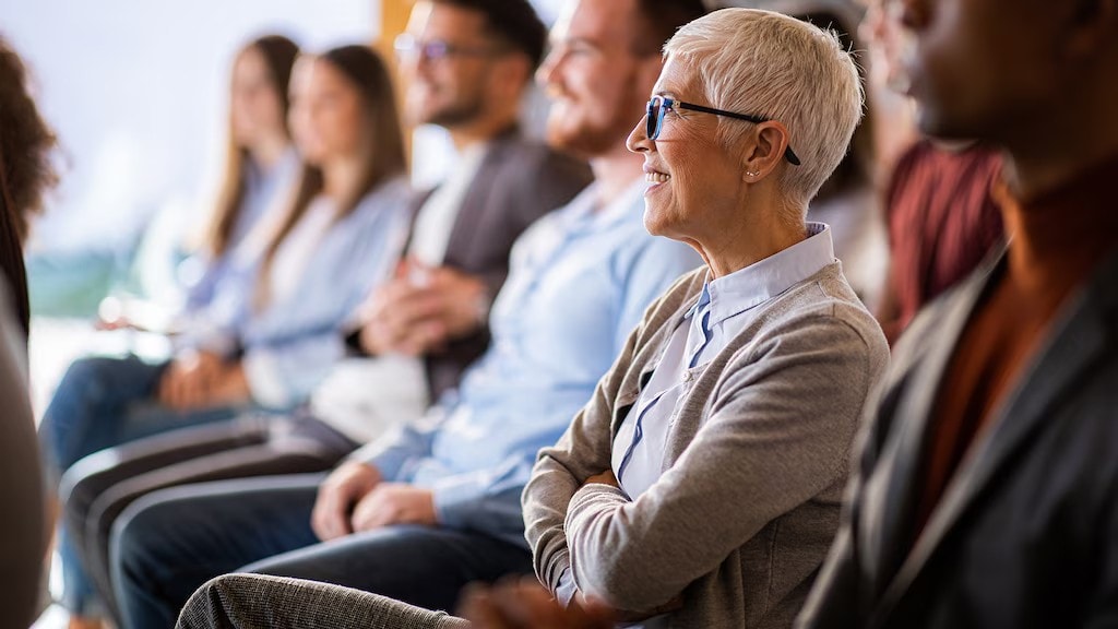 A photo of engaged audience listening attentively, highlighting effective audience engagement strategies during presentations.