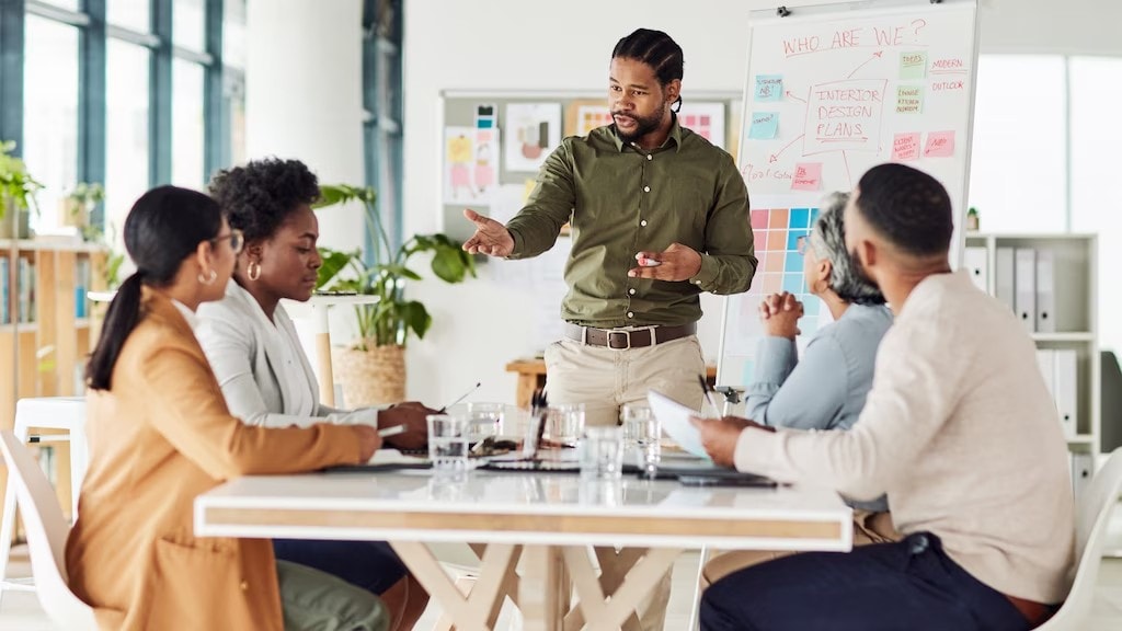 A photo of a person delegating tasks during a meeting, highlighting the importance of delegating tasks effectively.