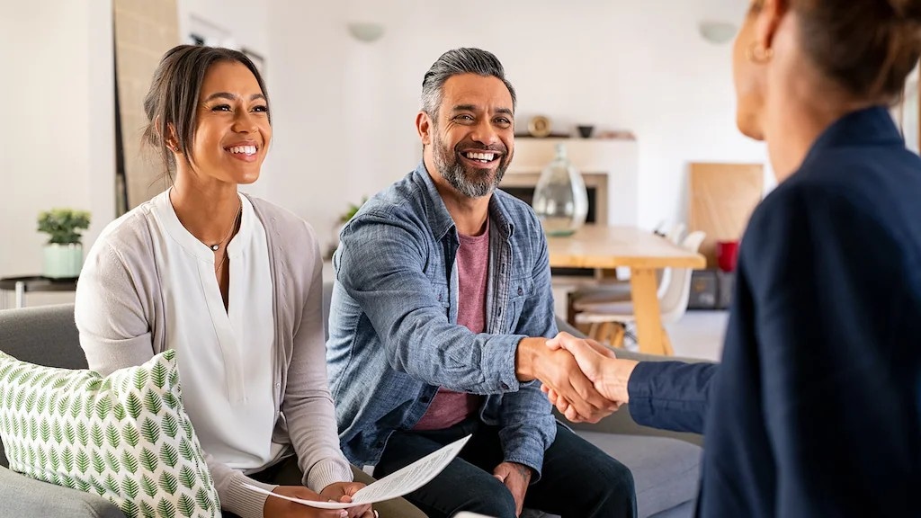 A photo of a couple meeting with a consultant, emphasizing customer behavior analysis to understand client needs and preferences.