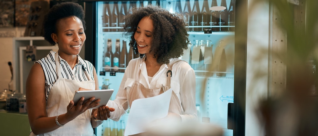 Shot of two young women using a digital tablet while doing inventory in a waste free store