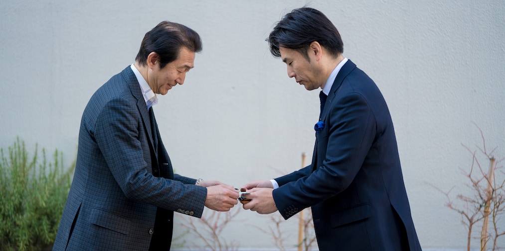 Two Japanese business men exchanging business cards. Tokyo, Japan