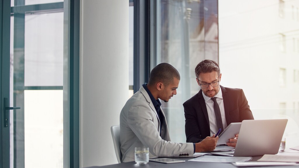 Shot of two businessmen having an office meeting