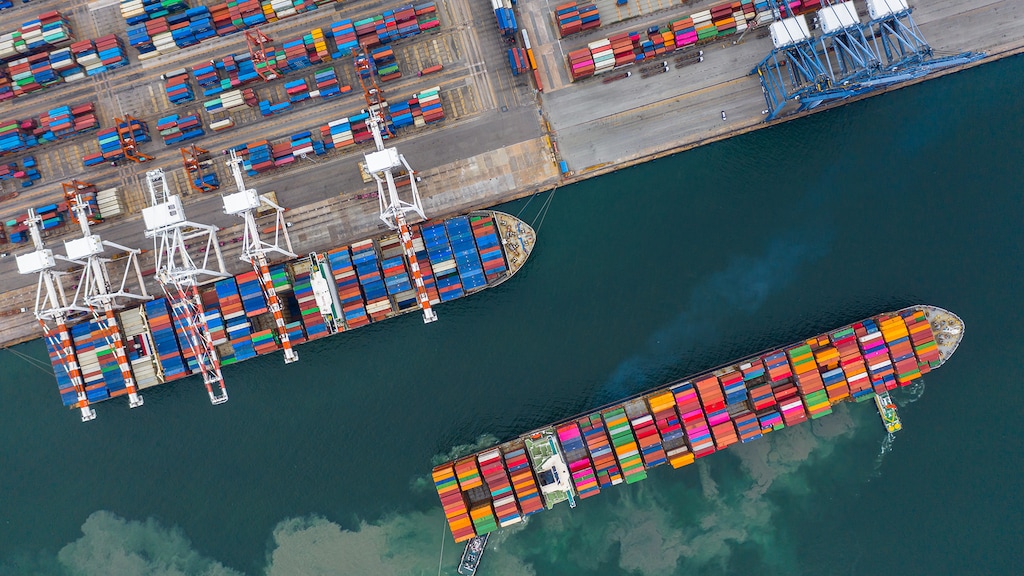 business plans related to social work Aerial view cargo ship terminal, Unloading crane of cargo ship terminal, Aerial view industrial port with containers and container ship.