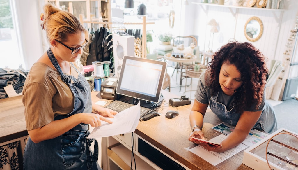 employees in a boutique checking sales