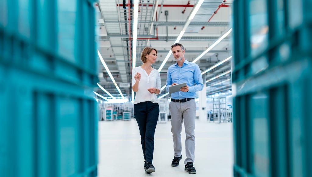 Two people examining a warehouse