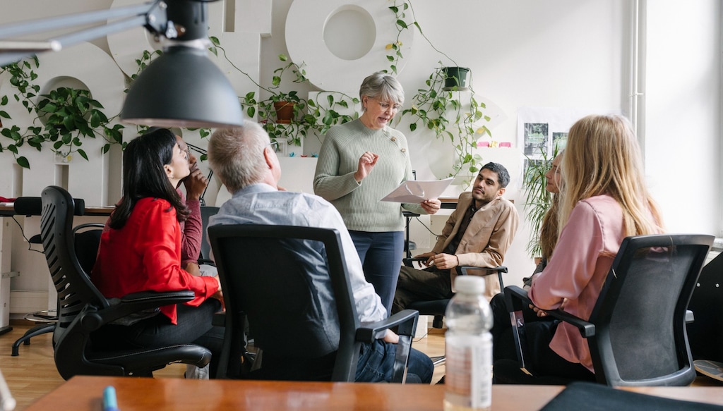 business owner having a meeting with her team