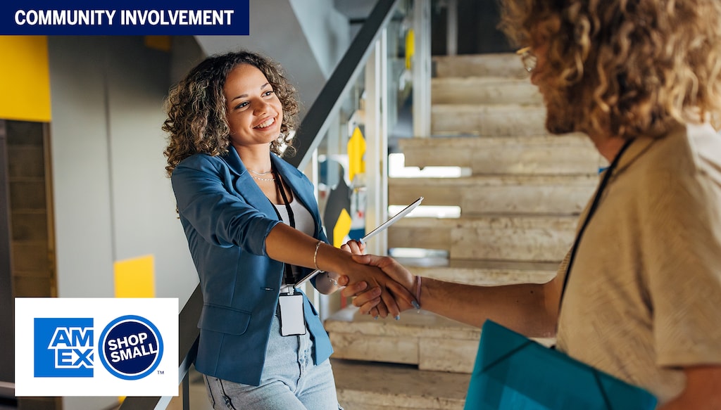 woman with clipboard shaking hands