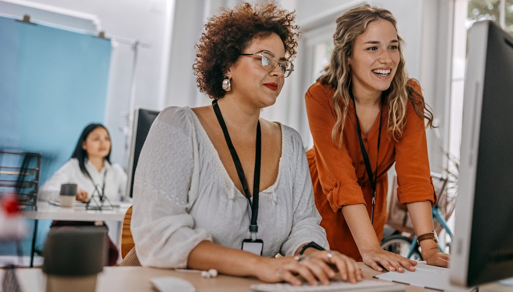 two women looking at computer