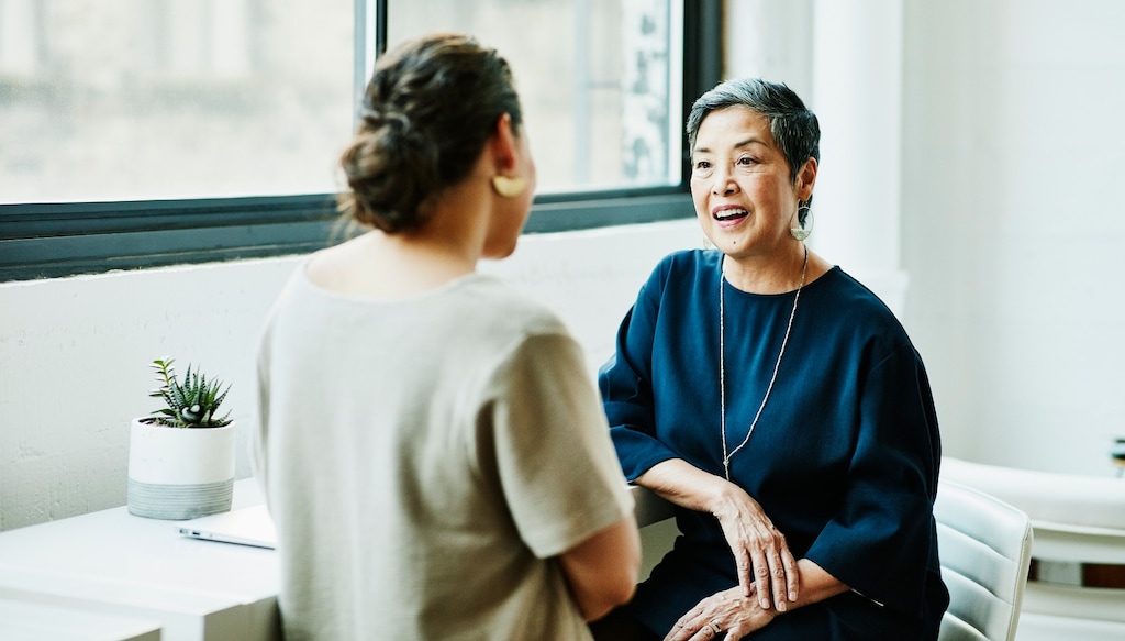 Two women sitting down and talking