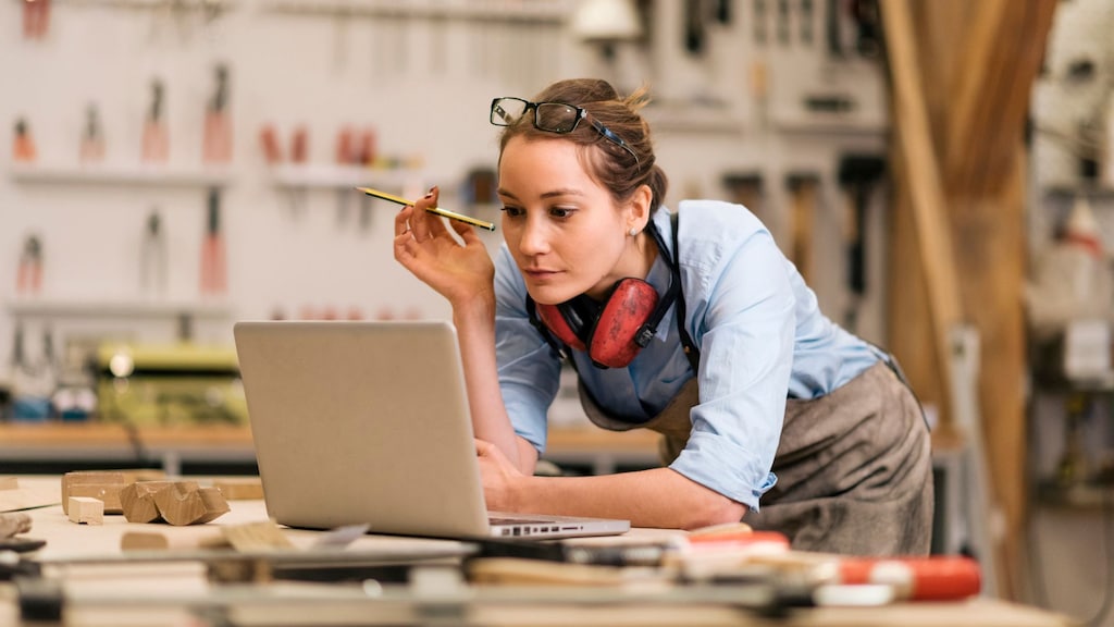 woman checking computer in her shop