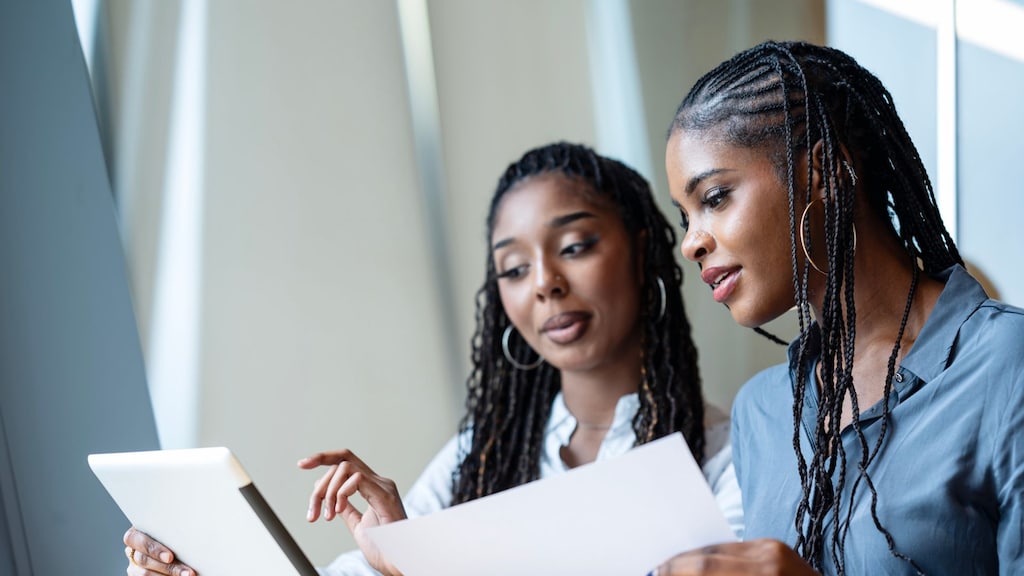 two women looking over paperwork