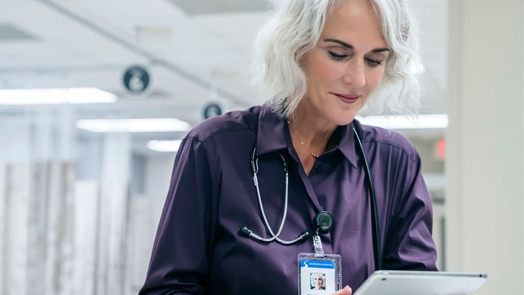 healthcare professional reviewing tablet