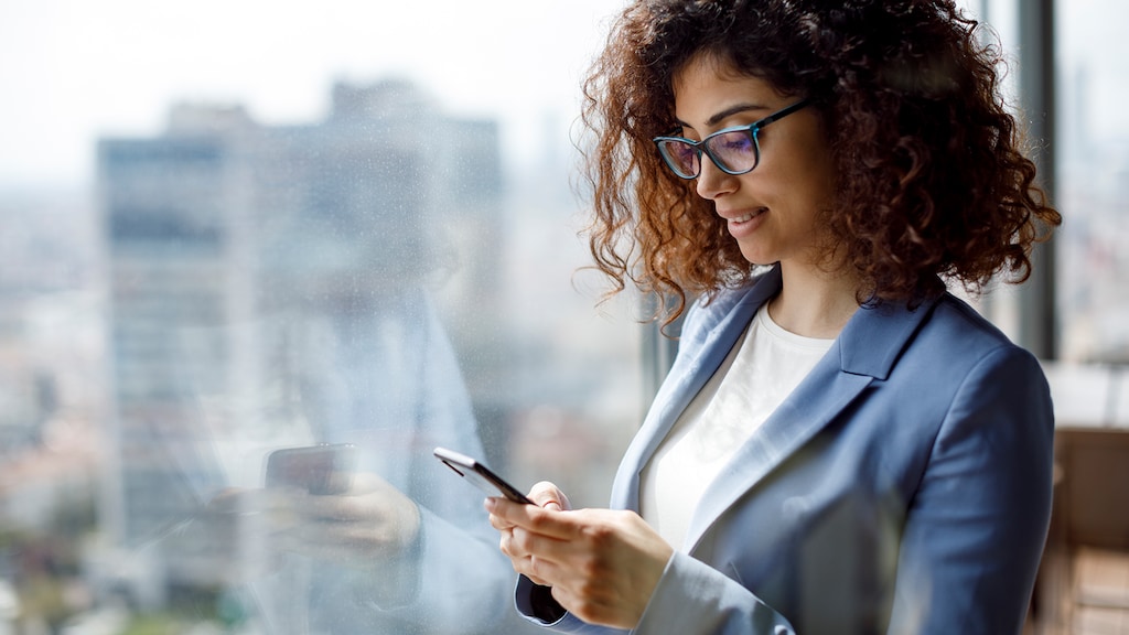 Business woman looking at cell phone