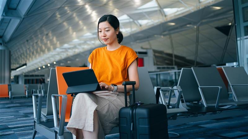 Woman working on tablet in airport
