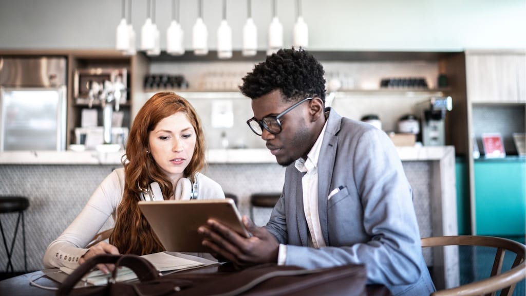 Colleagues reviewing info on a tablet
