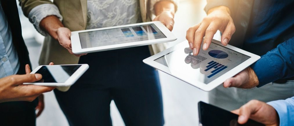 Cropped shot of unrecognizable businesspeople using their wireless devices in the office