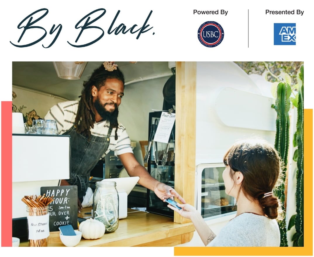 Employee in cafe food truck receiving a credit card from a customer