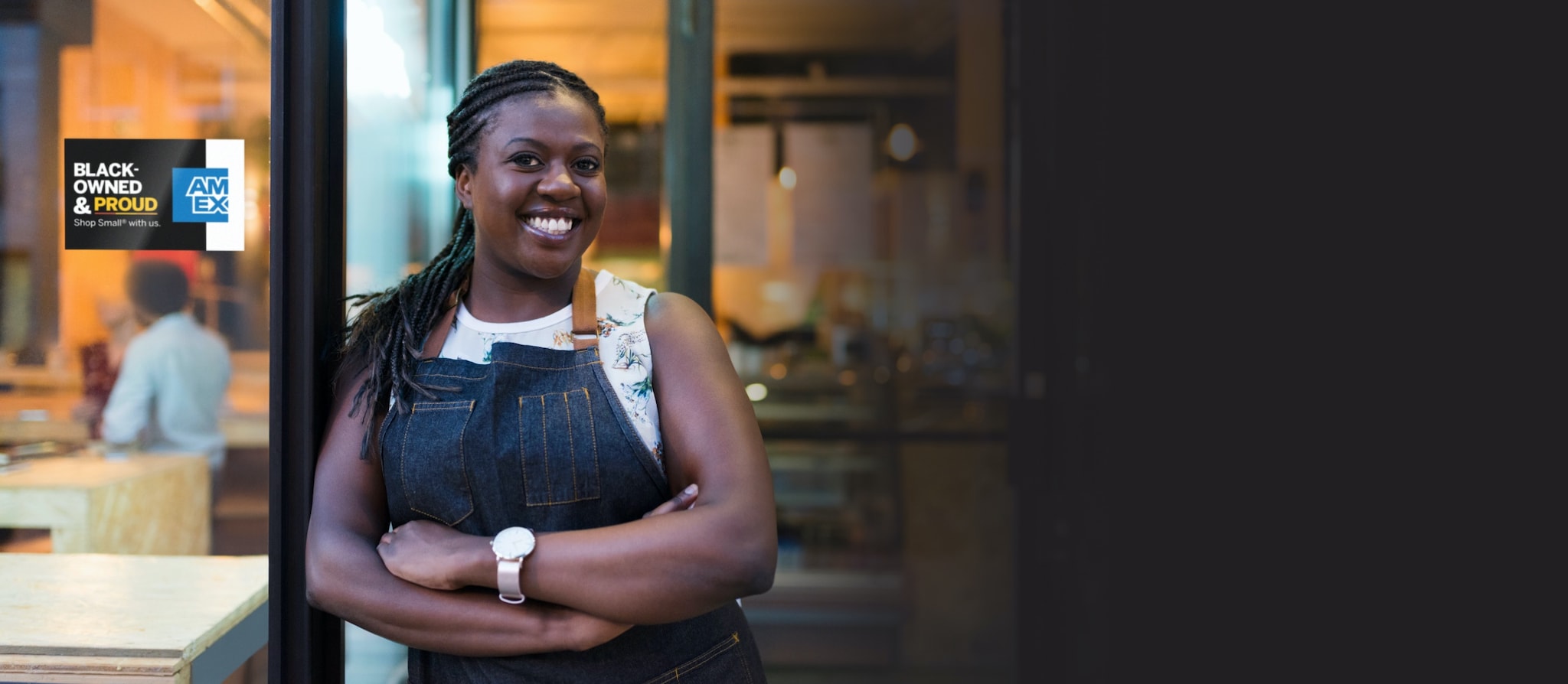 Woman posing outside her business store