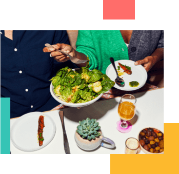 People at dinner grabbing a salad to share