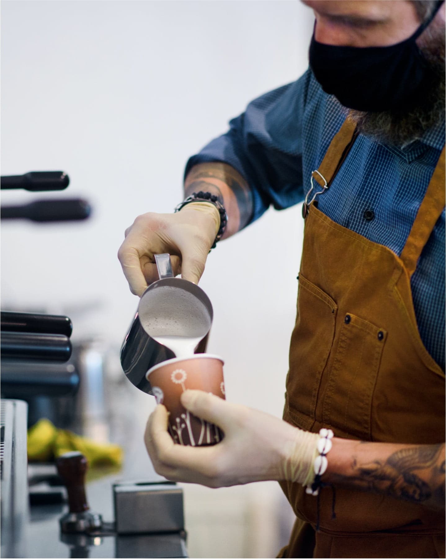 Barista serving a hot cup of coffee